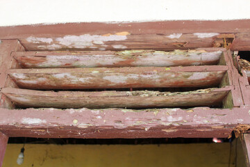 Old wooden windows that are worn and rotten
