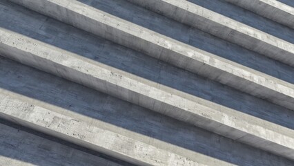 Staircase with gray concrete steps and a shadowy sky background.