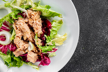 Tuna salad canned fish mixed green leaf lettuce seafood appetizer vegetable dish organic fresh tasty gourmet food background on the table rustic top view copy space vegetarian food pescetarian diet