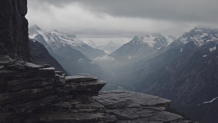 Breathtaking mountain range with dense forest and a clearing at the bottom.