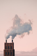 Industrial chimney with smoke against pastel sky – environmental concept