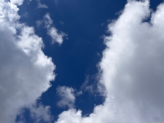 Beautiful blue sky with white clouds. The sky was clear and bright, and clouds were scattered all...