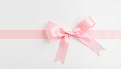 Elegant pink ribbon tied in a bow on white surface, minimalist beauty