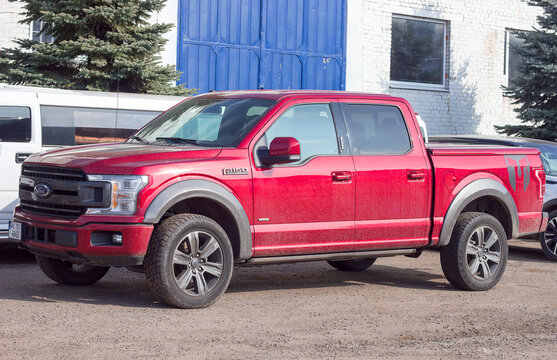 Ford F-150 display red at the dealership. Ford F150 is available  XL, XLT, Lariat, King Ranch, Platinum and Limited models.
