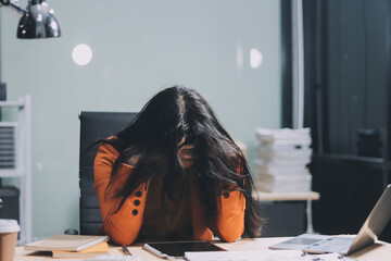 Asian women are stressed while working on laptop, Tired asian businesswoman with headache at...