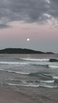 Moonrise in Campeche, Florianopolis, Brazil. Aerial view, vertical video.