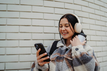 Portrait of a teenage girl smile and use cellphone to take self portrait or video call