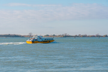 Yellow water taxi cruising through the calm waters of the lagoon
