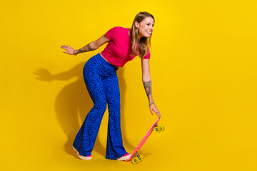 Cheerful Young Woman on Roller Skates Posing Against a Vibrant Yellow Background