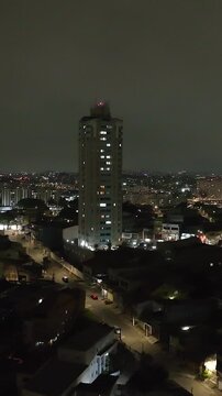 Itaquera neighborhood in S&atilde;o Paulo at night. Aerial view. Vertical video.