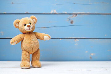 brown teddy bear sitting on top of a wooden table