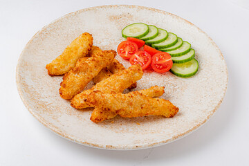 Crispy fried fish fillets with fresh cucumber and vibrant cherry tomatoes