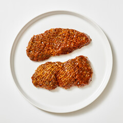 spicy tenderized beef cutlets on white background