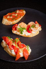 Elegant bruschetta on a dark plate, showcasing a delightful mix of fresh ingredients