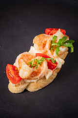 Savory shrimp bruschetta showcases vibrant tomatoes and arugula atop toasted artisan bread