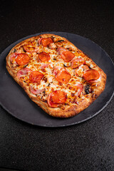 Freshly baked pepperoni pizza with crispy edges, melting cheese, and savory toppings awaits diners