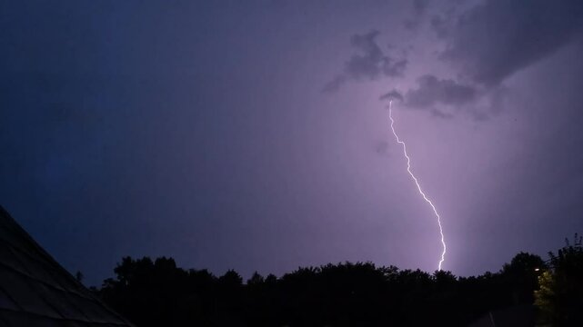A dramatic scene unfolds as a bolt of lightning, showcasing natures power. Real flashes of lightning over the sea during a powerful thunderstorm. Lightning slow motion 
