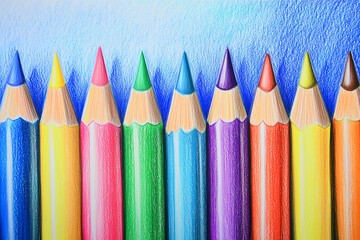 Close-up of sharpened colored pencils against blue background