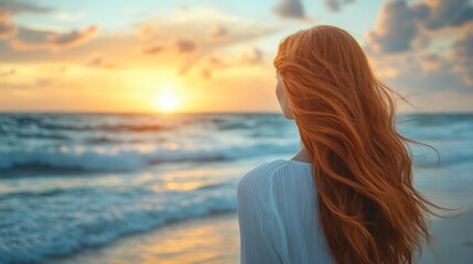 Fototapeta premium Woman watching sunrise at beach
