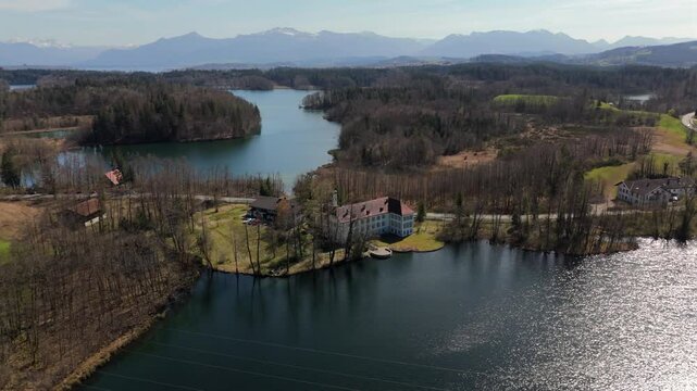 Aerial view Schloss Hartmannsberg, historic former moated castle between Schlosssee and Langbuergner See in Hartmannsberg, Bad Endorf, Rosenheim district, Bavaria, Germany. Baudenkmal. Lake and castle