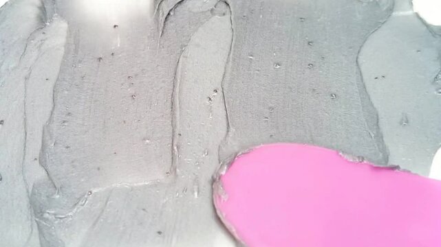 Black cream texture face wash, shampoo, cleanser, cosmetic or skincare product on a surface