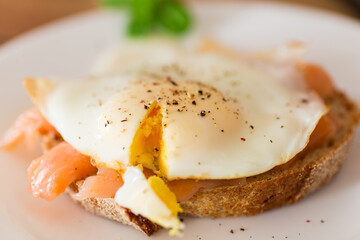 Dietary slice of bread with cooked egg and lightly salted red fish