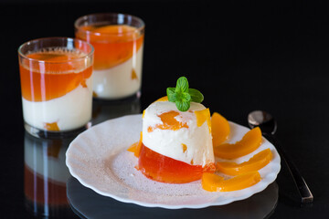 Layered fruit dessert with jelly, cream and fresh mint