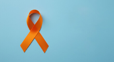 Skin cancer awareness month concept. Orange color ribbon on light blue background. Symbolic for Multiple Sclerosis day, self harm awareness, leukemia and kidney cancer. Poster, banner with copy space.