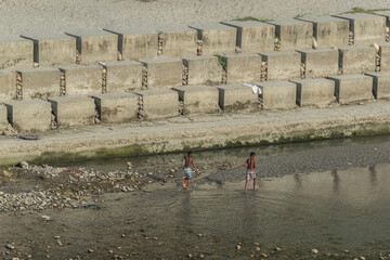 Two asian boys on the bank of the Ganga River