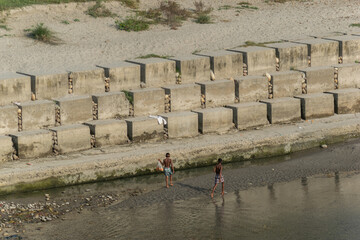 Two asian boys on the bank of the Ganga River