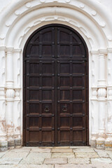 Old fashioned entryway with iron handles and hinges, historic architecture