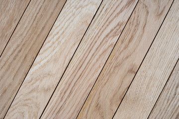 Diagonal light wood planks with natural grain and seamless texture for flooring, interior design, and background use. Wooden surface ideal for wallpaper, banner, and print templates.