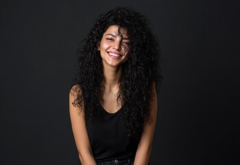 Fototapeta premium A woman with black hair and a beautiful, long curly hairstyle has a healthy teeth smile