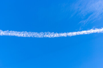 Contrails appearing in the sky in summer