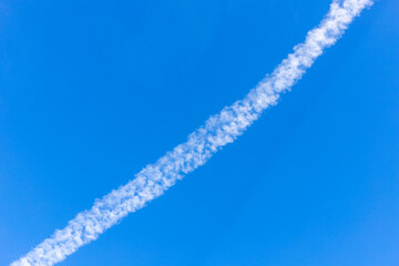 Contrails appearing in the sky in summer