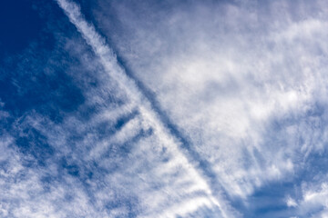 Contrails appearing in the sky in summer