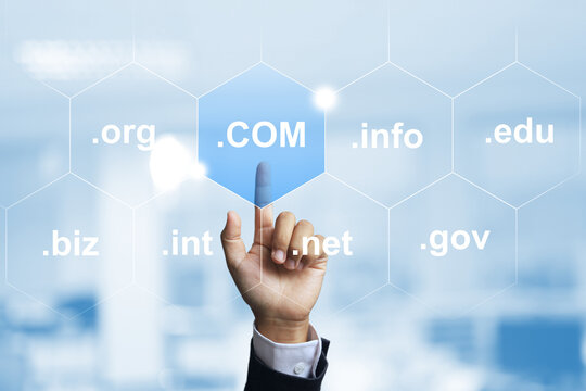 Domain name concept with businessman hand select .com to be a top level of domain in business website
