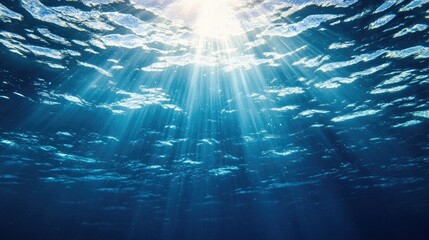 Underwater blue background in ocean with sunbeams