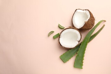Hair treatment. Fresh coconut and aloe leaves on beige background, flat lay. Space for text