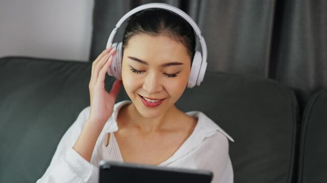 Lady searching and listening to music on phone at home