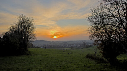 Fototapeta premium Sunset sky over fields and hills of Flemish Ardennes near Oudenaarde, Flanders, Belgium 