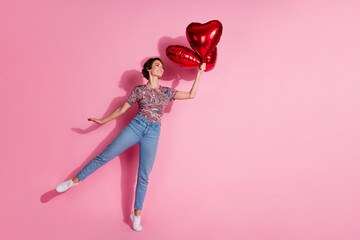 Photo of adorable lovely girl wear stylish clothes hold balloon empty space isolated on pink color background
