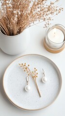 Obraz premium Golden hairpins and earrings on ceramic plate, modern accessory trend