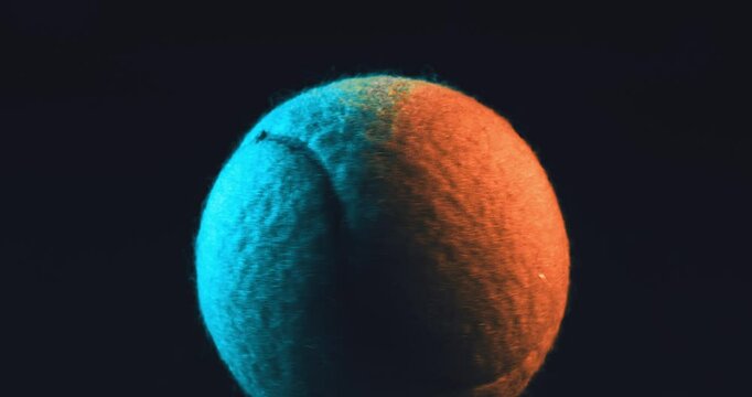 Close-up of a Tennis Ball under Studio Lighting. High-quality close-up shot of a tennis ball illuminated with dramatic studio lighting on a dark background. Sport, tennis, focus, competition, training