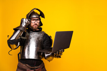 Medieval knight modernized with glasses and laptop on vibrant yellow backdrop