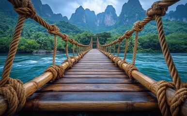 Obraz premium A bridge over a river with a rope bridge