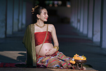 Pretty Asian pregnant woman in traditional Thai dress, Lanna style. Beautiful conventional. Asian...