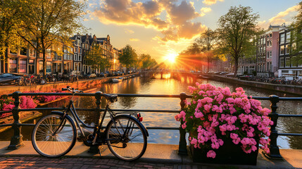 Amsterdam Canal Sunset: A picturesque view of the iconic Amsterdam canal at sunset. With a charming bridge, vibrant flowers, and bicycle adding to the scenic beauty