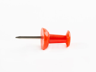 On a white background there is a red pushpin. Isolated