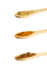 Set of dry, ground spices in spoons on a white background: cinnamon, ginger, turmeric. Isolated